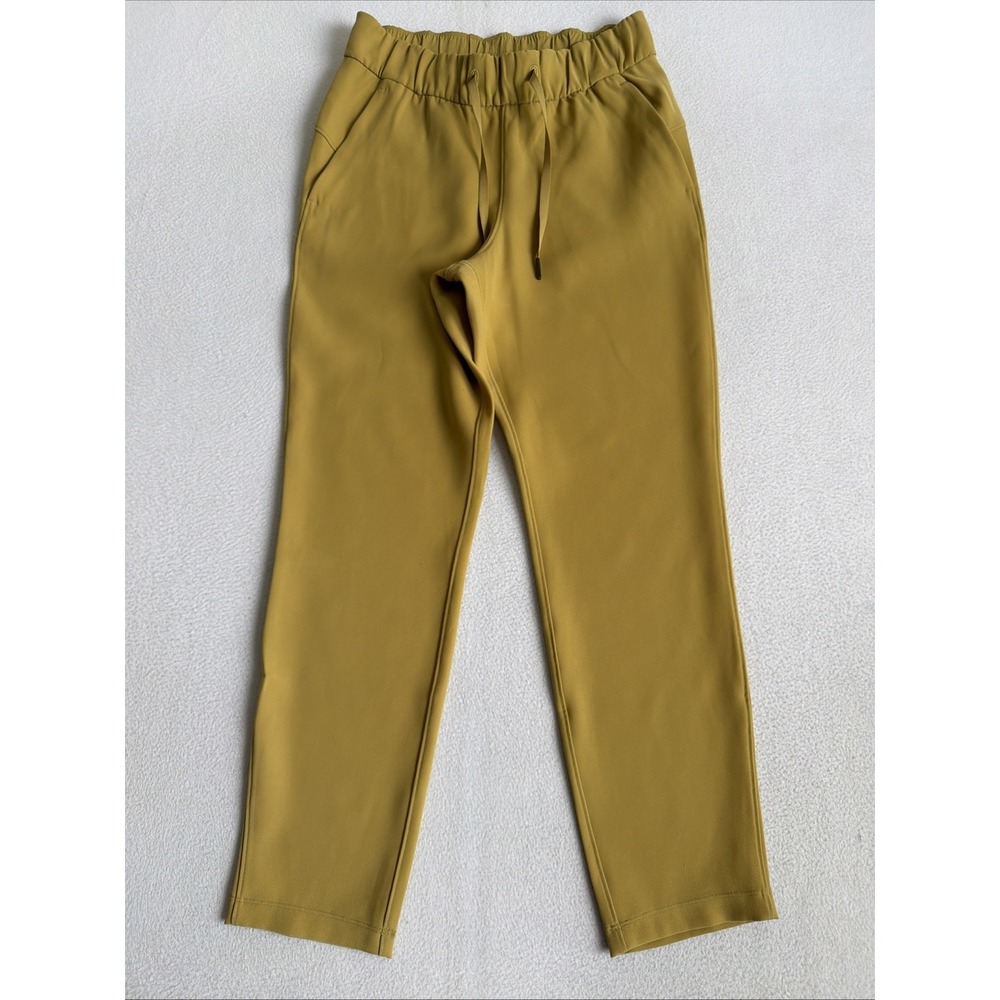 Lululemon On The Fly 7/8 Pants Gold Size 4 Travel Woven Drawstring Tapered Leg